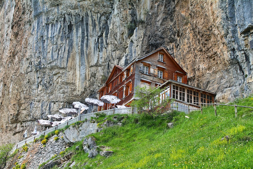 Traditional Swiss alpine chalet facade with wooden balconies in the mountains